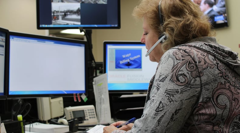 In this photo from 2016, an administrative typist answers calls about water and sewer issues at the city of Dayton’s Water Utility Field Operations dispatch center. CORNELIUS FROLIK / STAFF
