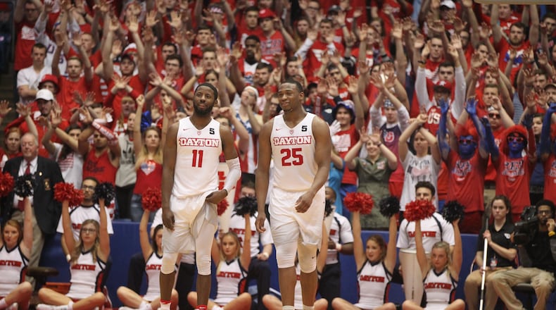 Dayton’s Scoochie Smith and Kendall Pollard watch as a teammate shoots a free throw in the second half against George Mason on Tuesday, Feb. 21, 2017, at UD Arena. David Jablonski/Staff
