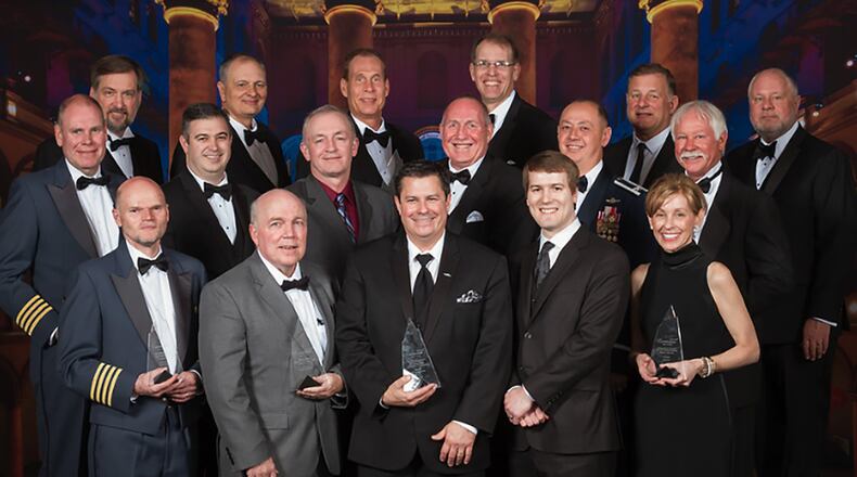 Kevin Price (maroon shirt), Air Force Research Laboratory program manager, stands to the left of Edward Griffin of Lockheed Martin along with other winners of the 2019 Aviation Week Laureate Awards at a formal ceremony at the National Building Museum in Washington, D.C., March 14. AFRL, Lockheed Martin and Office of the Secretary of Defense won the safety award in the defense category for Auto-ICAS, a life-saving aircraft technology. (Courtesy photo/Chris Zimmer, Aviation Week)