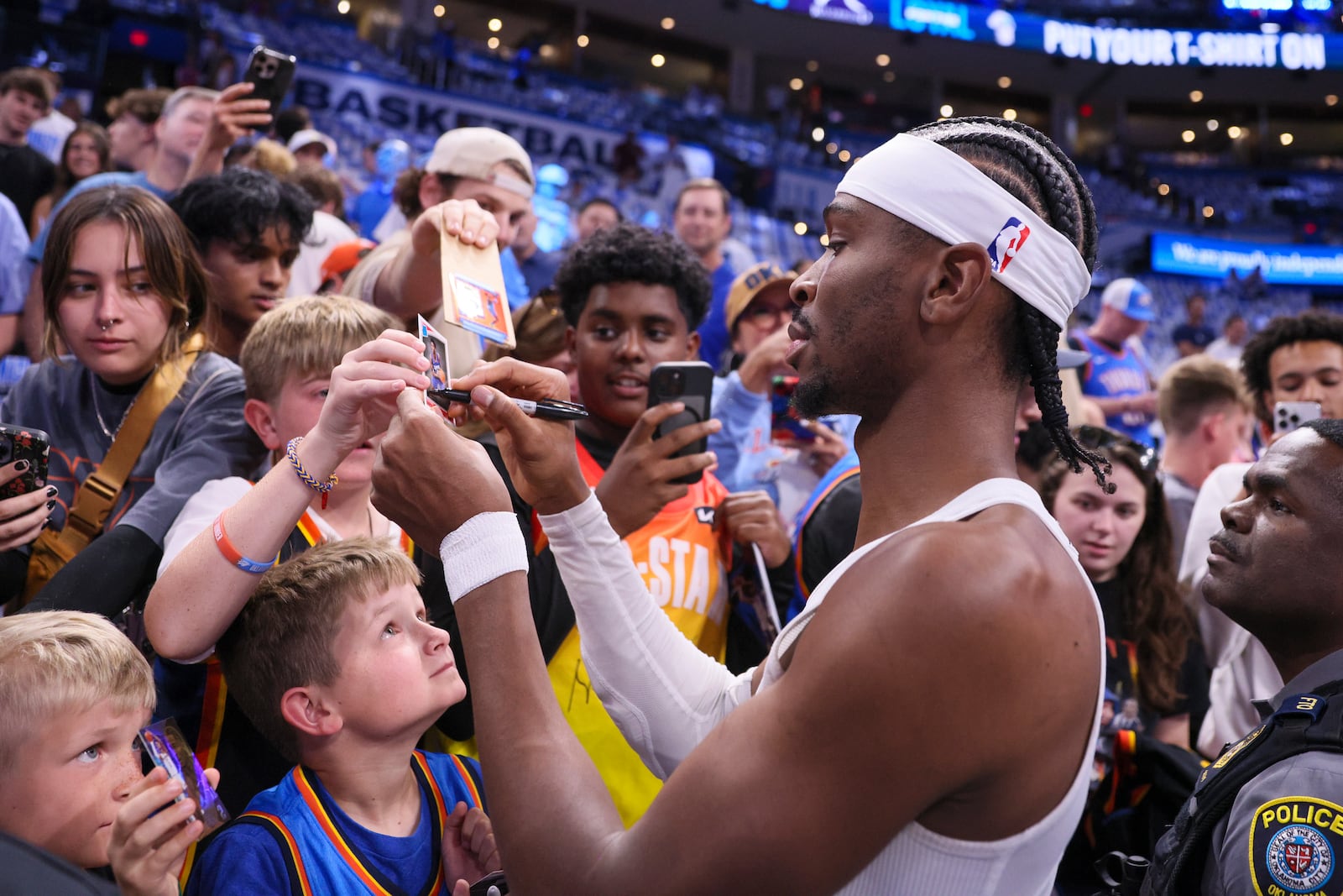 Oklahoma City Thunder guard Shai Gilgeous-Alexander signs autographs prior to Game 1 vs. Minnesota Timberwolves in a NBA basketball Western Conference Finals playoff series Tuesday, May 20, 2025, in Oklahoma City. (AP Photo/Nate Billings)