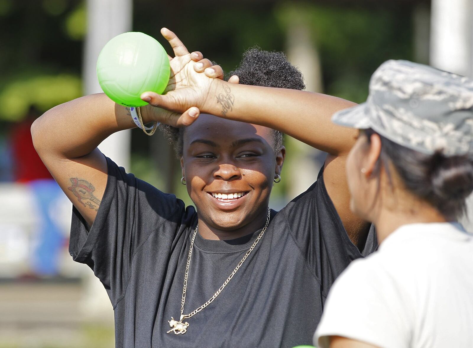 Sunrise Camp counselor Pasha Rivers talks with an Ohio Air National Guard member who attended the camp with a unit from Springfield. TY GREENLEES / STAFF