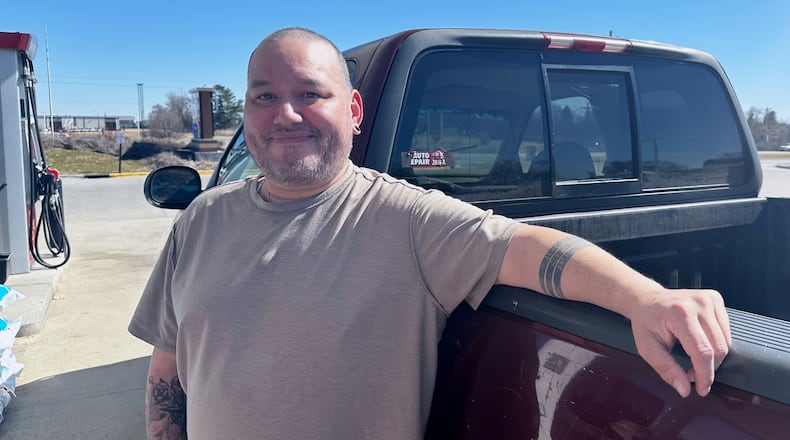 Francisco Castillo stands next to his son's Ford F-150 after filling up, Monday, March 9, 2026, at a gas station in De Soto, Iowa. (AP Photo/Hannah Fingerhut)