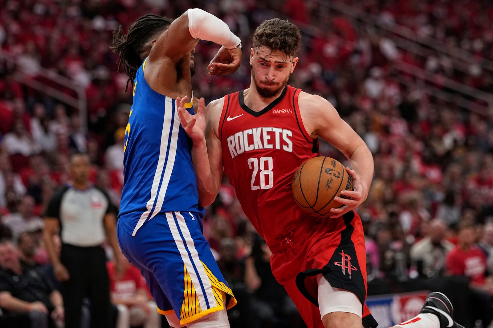 Houston Rockets center Alperen Sengun (28) shoots over Golden State Warriors forward Kevon Looney during the first half of Game 5 of an NBA basketball first-round playoff series, Wednesday, April 30, 2025, in Houston. (AP Photo/David J. Phillip)
