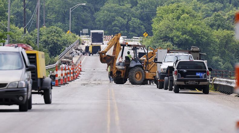 A bridge that links the city to Madison Twp. on Ohio 122 over the Great Miami River is seen Mon., June 13, 2022. Contractors are there to remove debris from the main channel of the river and make bridge repairs. NICK GRAHAM/STAFF