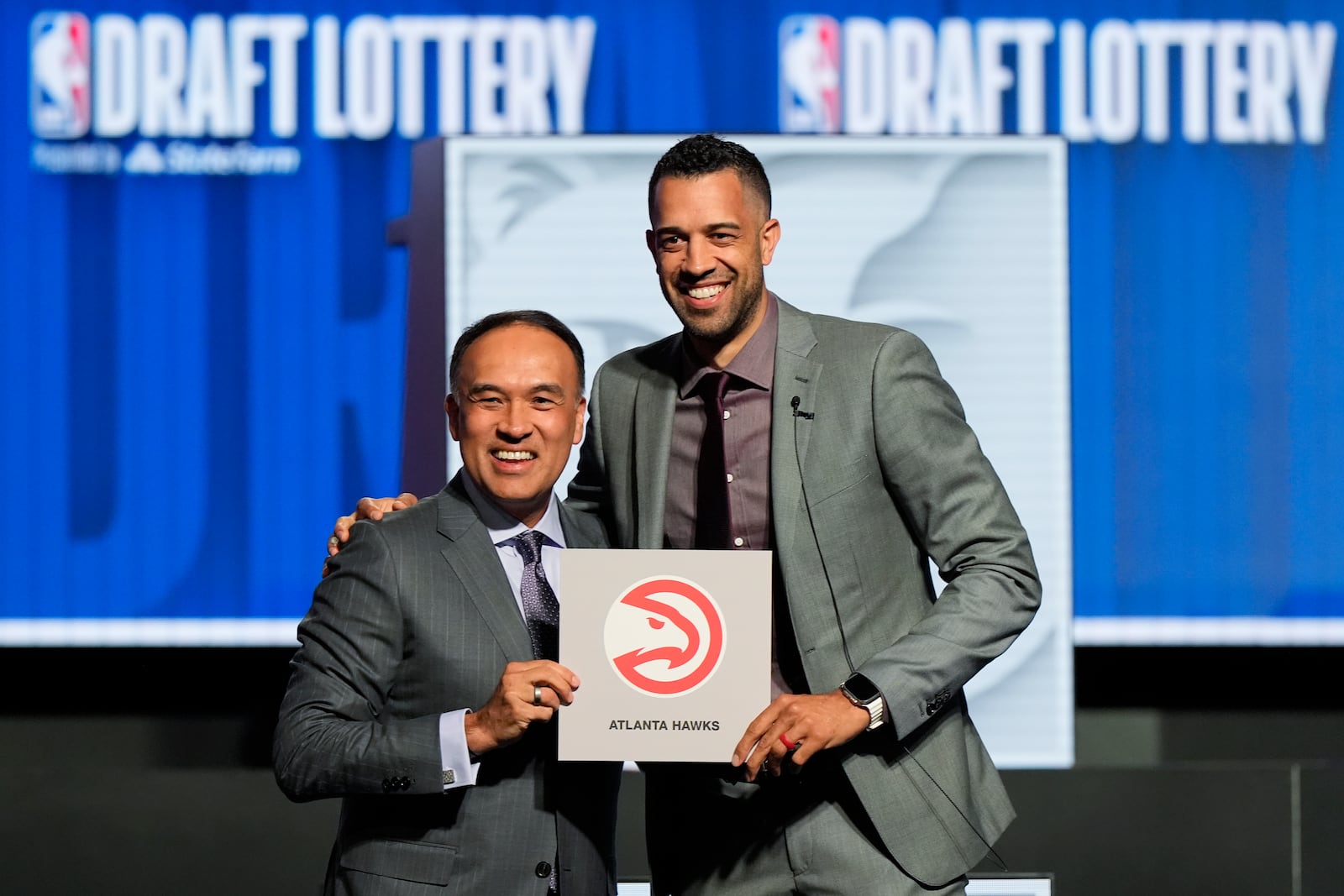 FILE - Atlanta Hawks general manager Landry Fields, right, and NBA Deputy Commissioner Mark Tatum pose for photos after Tatum announced that the Hawks had won the first pick in the NBA draft, during the draft lottery in Chicago, Sunday, May 12, 2024. (AP Photo/Nam Y. Huh, File