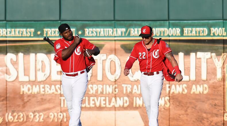 GOODYEAR, ARIZONA - MARCH 19: Yasiel Puig #66 and Derek Dietrich #22 of the Cincinnati Reds walk to the dugout prior a spring training game against the Chicago White Sox at Goodyear Ballpark on March 19, 2019 in Goodyear, Arizona. (Photo by Norm Hall/Getty Images)
