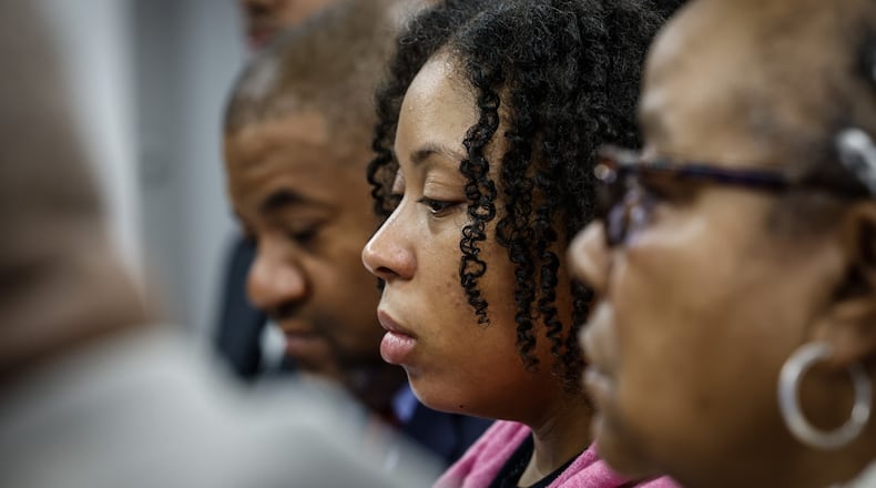 Michelle Cooper, right and Brittney Cooper, center, meet with the press Wednesday December 7, 2022 at Wright and Schulte law office in Dayton. The Coopers filed a lawsuit accusing Lyft of failing to protect Brandon Cooper after he was gunned down during a robbery earlier this year. Brittney was Brandon's wife and Michelle was Brandon's mother. JIM NOELKER/STAFF