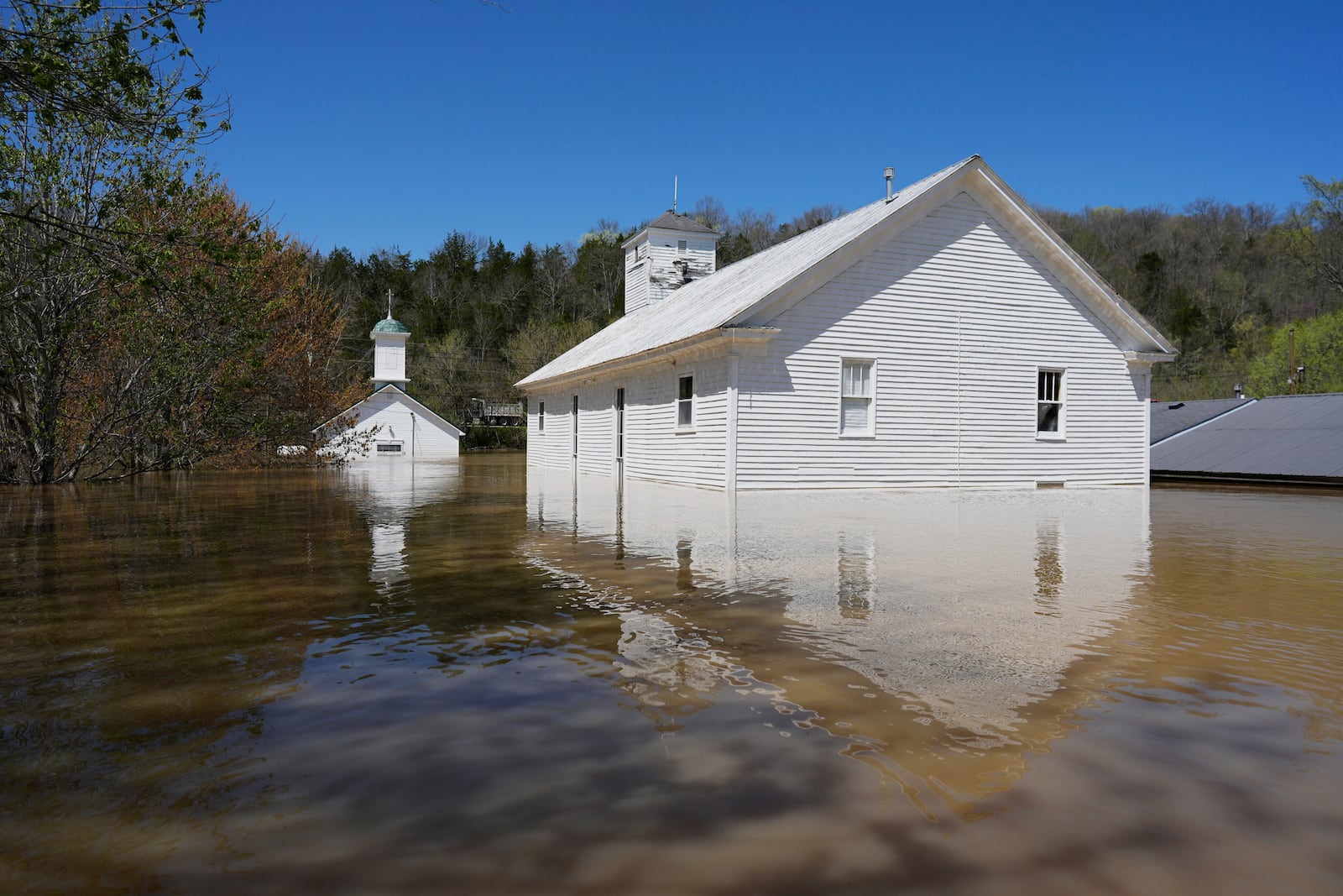Two churches, one Catholic and one Baptist are flooded by the Kentucky River in Lockport, Ky., Tuesday, April 8, 2025. (AP Photo/Carolyn Kaster)