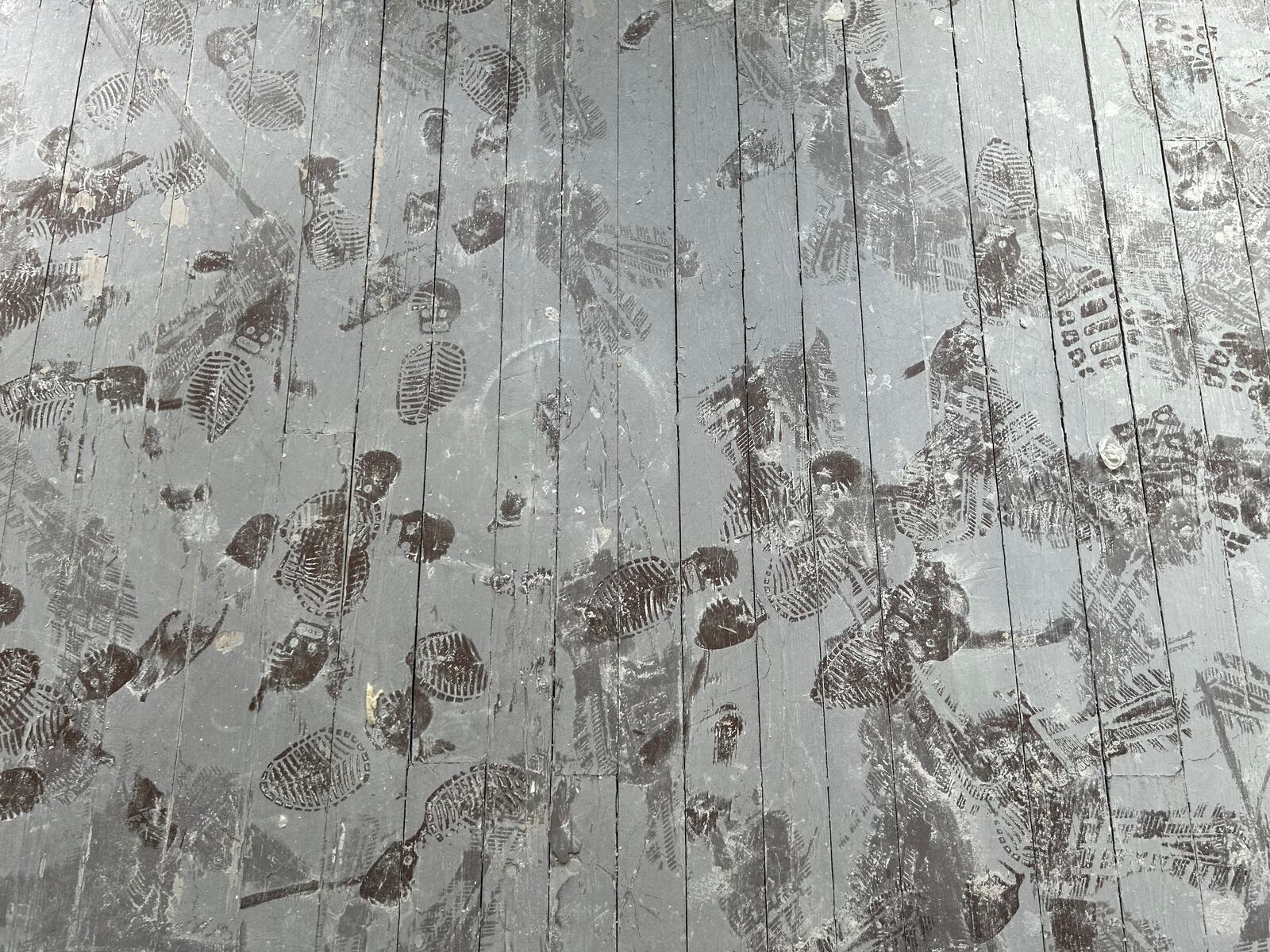 Dusty footprints appear on the floor of the East Dayton house Hartshorn is rehabbing. “Every house that I’ve bought has been abandoned. I come over with paint all over me, a working person, cause that’s what these neighborhoods are filled with: working people."