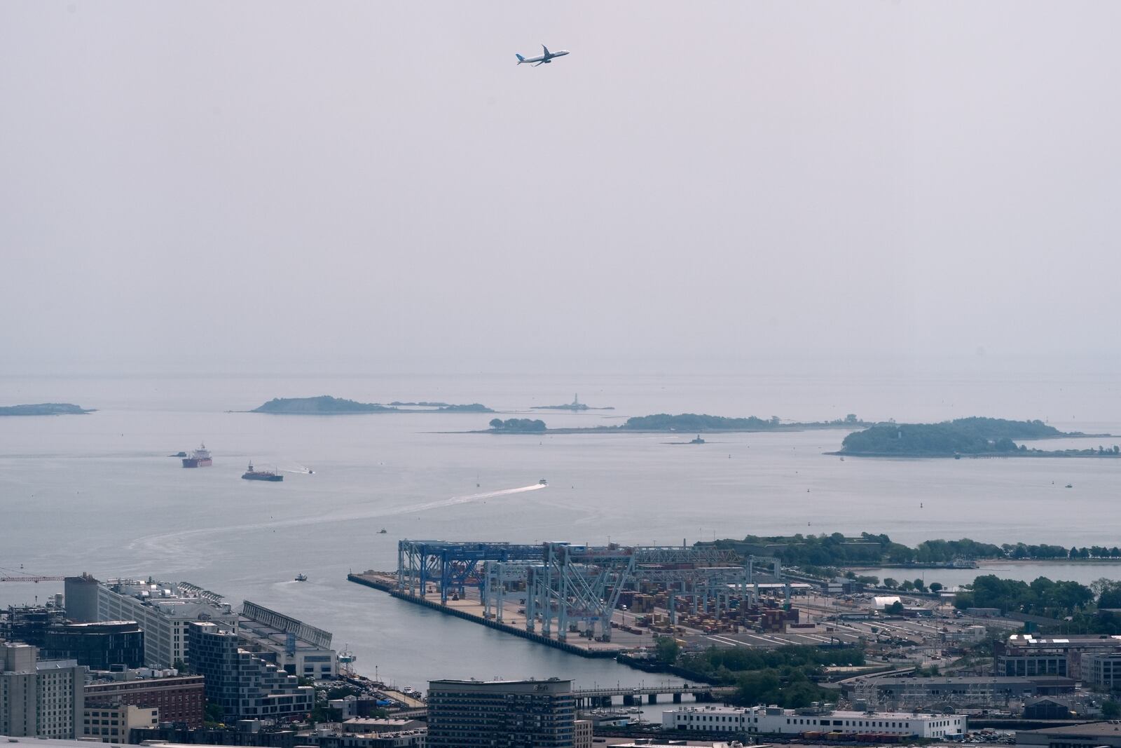 Hazy skies diminish the view of the Boston Harbor Islands, Wednesday, June 4, 2025, in Boston, Mass. (AP Photo/Robert F. Bukaty)