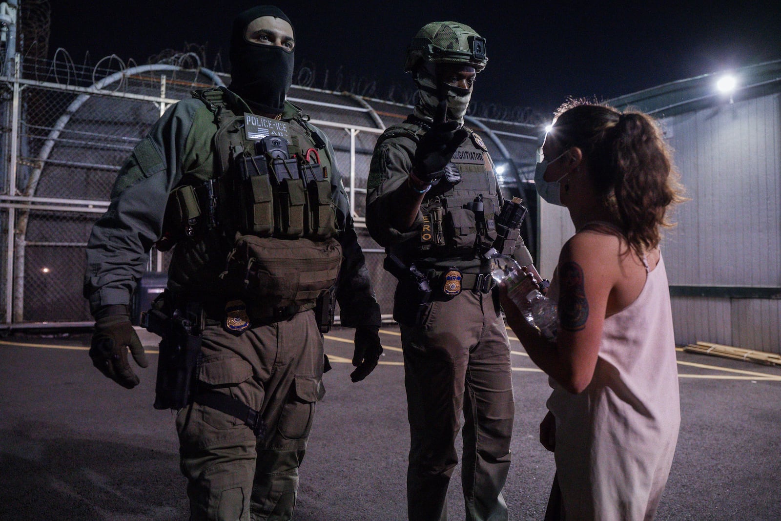 A protester confronts immigration enforcement agents outside the Delaney Hall Detention Facility during a protest over federal immigration enforcement raids on Thursday, June 12, 2025, in Newark, N.J. (AP Photo/Olga Fedorova)