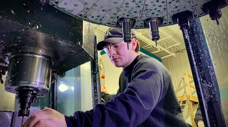 Cat-Wood Metalworks employee Trenton Chambers, does set up on a machine Thursday, January 23, 2025. MARSHALL GORBY \STAFF