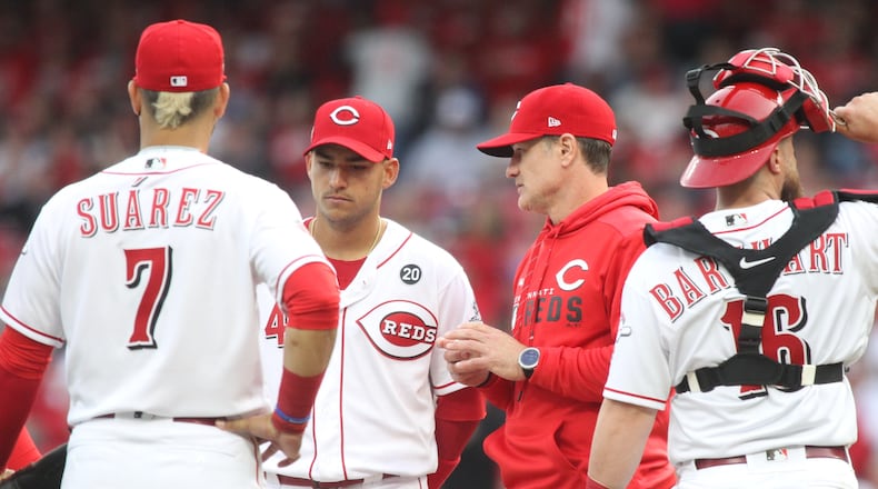 Reds manager David Bell makes a pitching change in the ninth inning against the Pirates on Opening Day on Thursday, May 28, 2019, at Great American Ball Park in Cincinnati.