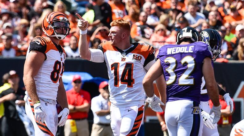 Cincinnati Bengals’ quarterback Andy Dalton signals for a first down after he gets his helmet ripped off during the play during their game against the Baltimore Ravens Sunday, Sept. 10 at Paul Brown Stadium in Cincinnati. NICK GRAHAM/STAFF