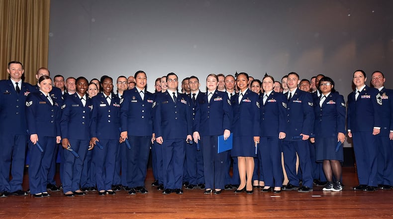 Col. Bradley McDonald (left), 88th Air Base Wing and installation commander, Chief Master Paul Eischen (second from right), 88th Air Base Wing interim command chief, and Chief Master Sgt. Keith Erb (right), chief enlisted manager of the United States Air Force Band of Flight, presented diplomas to the Spring 2018 Community College of the Air Force graduates stationed at Wright-Patterson Air Force Base during a ceremony at the base theater May 8. The Community College of the Air Force is a federally chartered degree-granting institution that serves the U.S. Air Force’s enlisted total force with WPAFB being one of 108 affiliated branches. (U.S. Air Force photo/Al Bright)