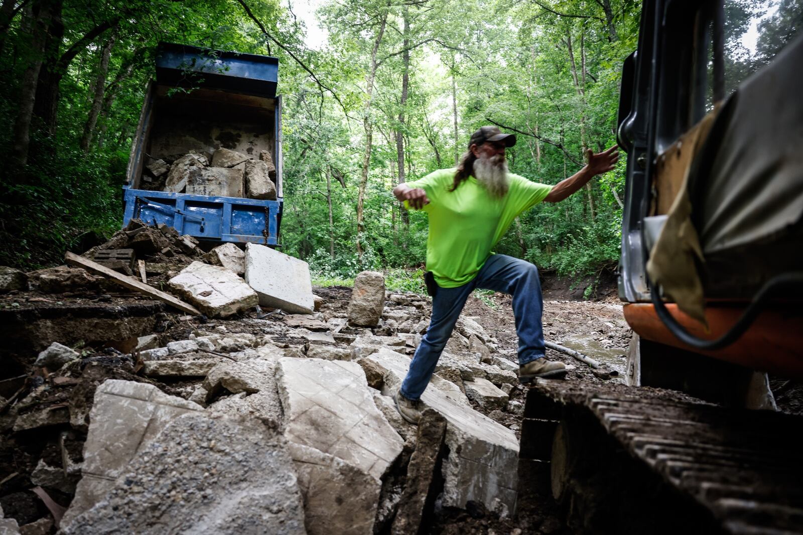 Earth and Pipe Contractors tracko operator, Rob Ringer jumps on his machine to fix Cook Rd. In Spring valley Twp. after Last Fridays storm washed out the road. Jim Noelker/Staff