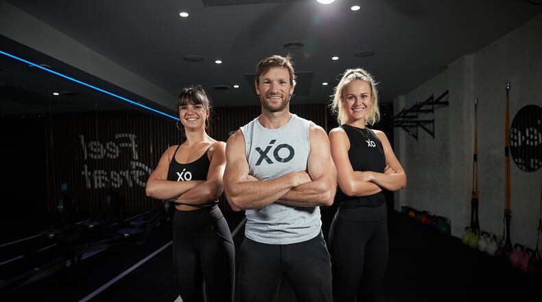 Jimmy Taylor, pictured here with two trainers, started XO Fitness & Wellness in Australia in 2016. He's planning to open a new location at 1027 S. Main St. in Centerville in early April. CONTRIBUTED
