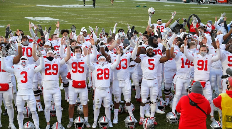 Ohio State players celebrate following an NCAA college football game against Michigan State, Saturday, Dec. 5, 2020, in East Lansing, Mich.  (AP Photo/Al Goldis)