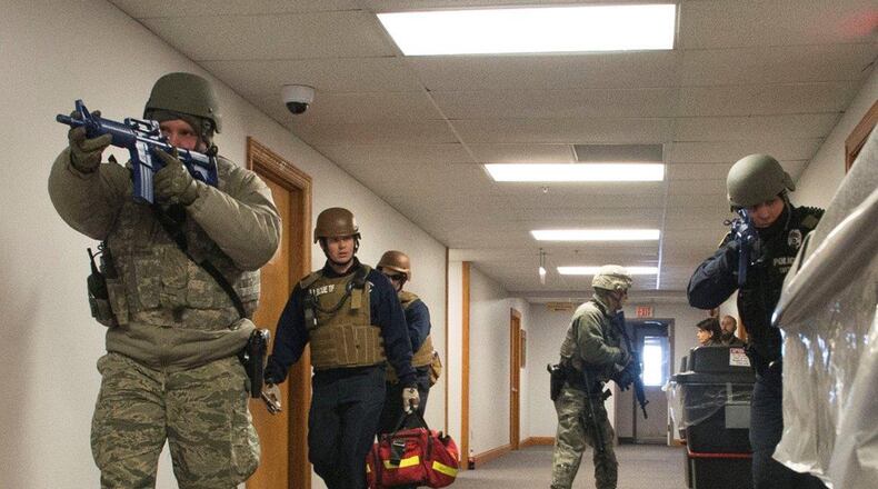 Wright-Patterson Air Force Base defenders and emergency response personnel enter a base facility during a previous active-shooter exercise. Active-shooter response will be the focus of a base-wide exercise Feb. 26. (U.S. Air Force photo/Wesley Farnsworth)