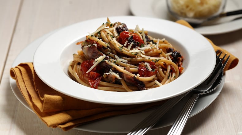 Long strands of bucatini, the pasta with a hole down the middle, are tossed with roasted tomatoes, radicchio and garlic. Styled by Mark Graham. (E. Jason Wambsgans/Chicago Tribune/TNS)