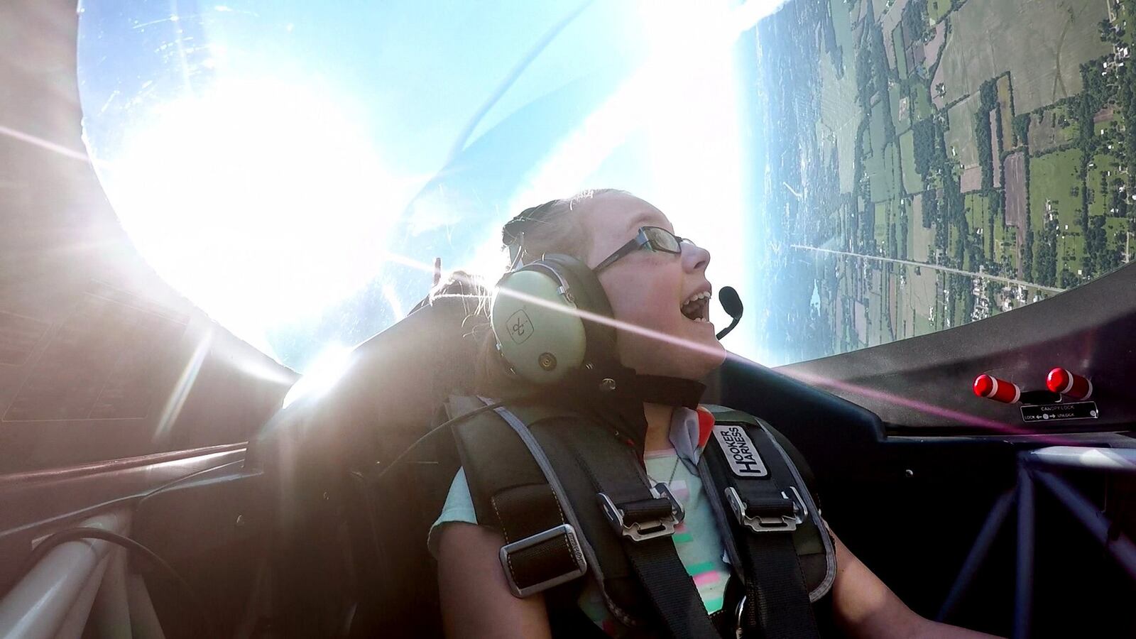 Olivia Collins, 12, was all smiles when air show legend Sean D. Tucker took her for her first airplane at the Dayton International Airport on Friday. Collins won the Young Eagles essay contest for the Dayton Air Show to earn this opportunity. The Young Eagles program was started by the Experimental Aircraft Association to expose young people to aviation through flight at their local EAA chapters. Tucker is currently chairman of Young Eagles program. SUBMITTED