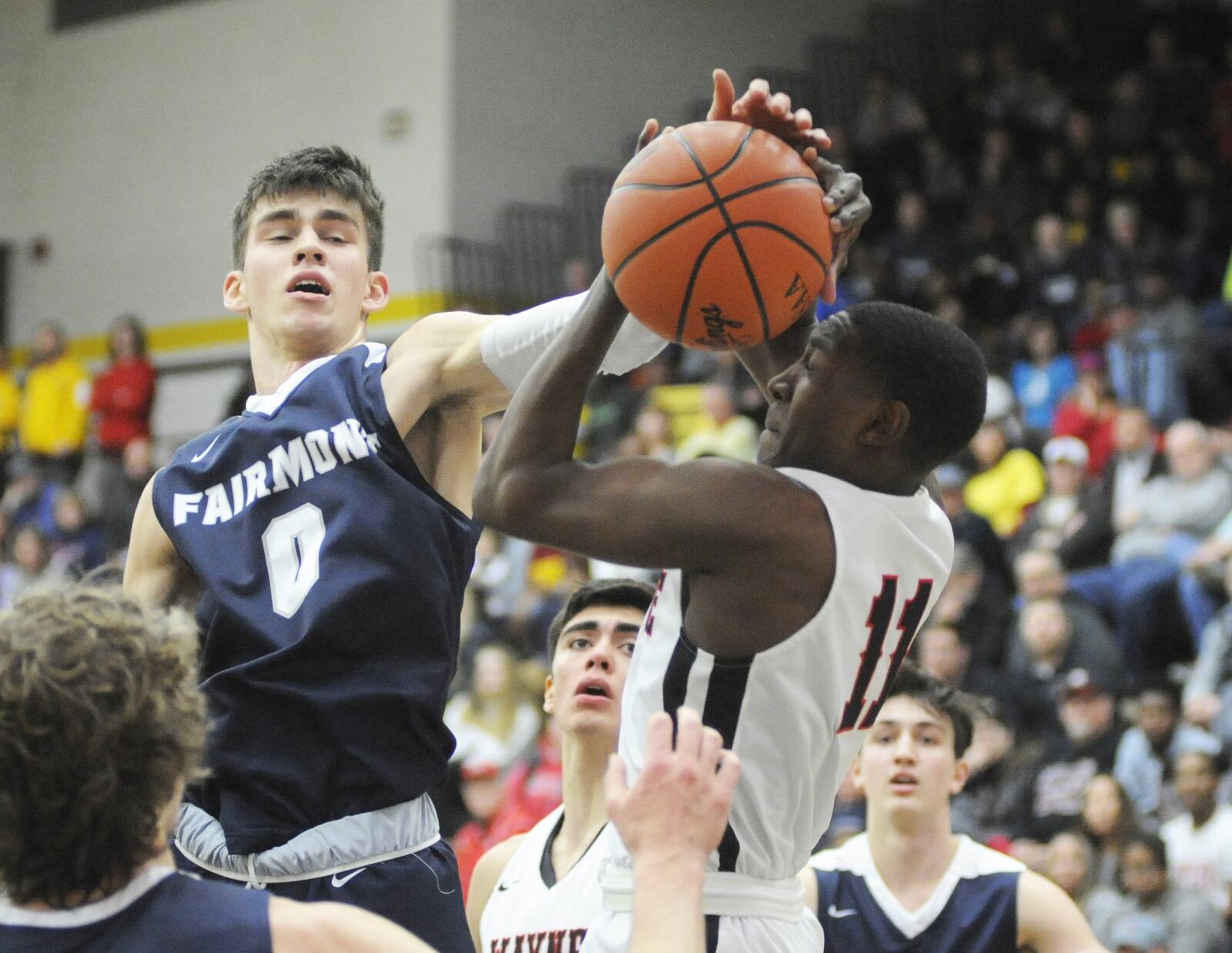 Fairmont’s Ryan Hall (0) confronts Jordan Long of Wayne (with ball). Fairmont defeated Wayne 51-43 in a boys high school basketball D-I sectional final at Centerville on Monday, March 4, 2019. MARC PENDLETON / STAFF