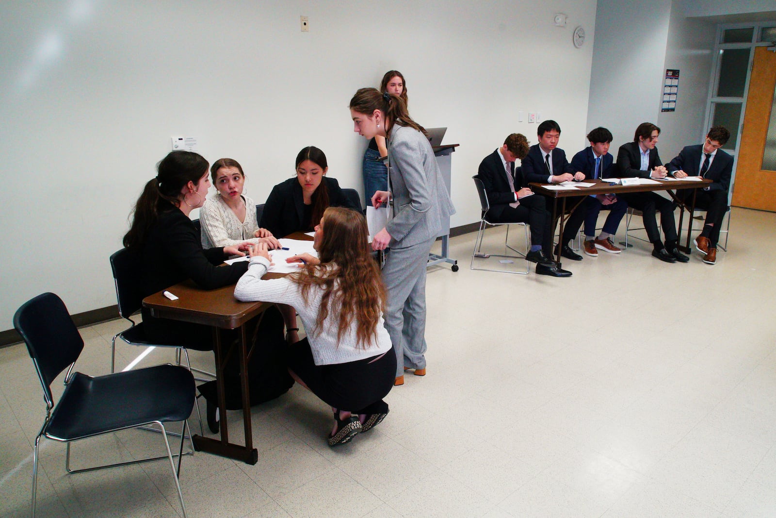 Students from Atlanta's Midtown High School, foreground, confer during a quarterfinal round at the National High School Ethics Bowl in Chapel Hill, N.C., on Sunday, April 13, 2025. (AP Photo/Allen G. Breed)