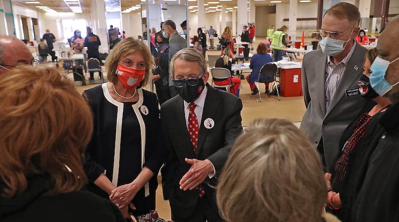 Governor Mike DeWine and his wife, Fran, talk with local officials as they visit the Clark County vaccine distribution center. BILL LACKEY/STAFF