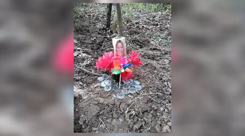 A memorial has been placed at the spot where the remains of Cheryl Coker were found Saturday evening./ CONTRIBUTED