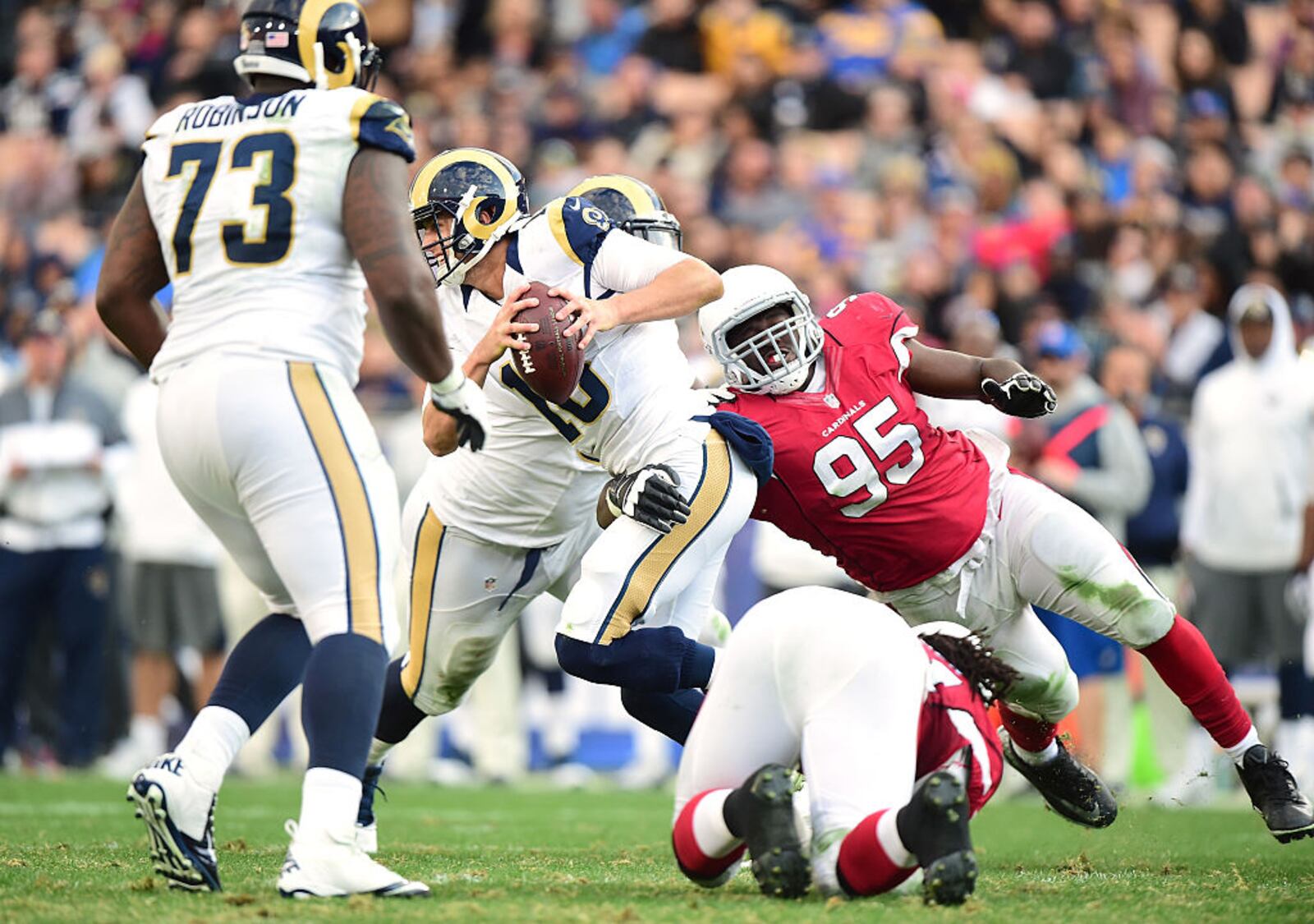 LOS ANGELES, CA - JANUARY 01: Jared Goff #16 of the Los Angeles Rams gets sacked by Rodney Gunter #95 of the Arizona Cardinals during the fourth quarter of a 44-6 Rams loss at Los Angeles Memorial Coliseum on January 1, 2017 in Los Angeles, California. (Photo by Harry How/Getty Images)