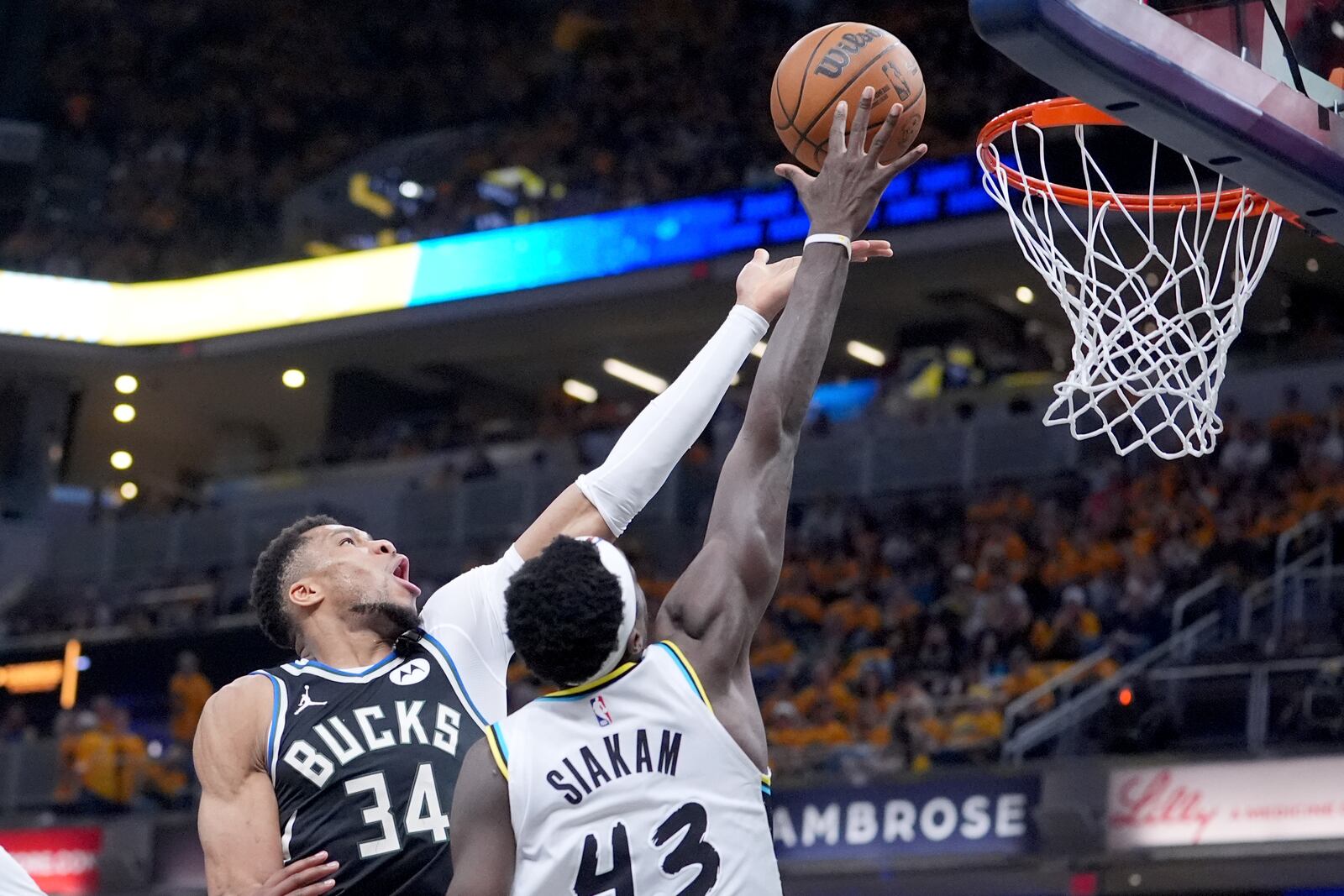 Milwaukee Bucks' Giannis Antetokounmpo (34) heads to the basket as Indiana Pacers' Pascal Siakam (43) defends during the second half of a first-round NBA basketball playoff game, Saturday, April 19, 2025, in Indianapolis. (AP Photo/Michael Conroy)