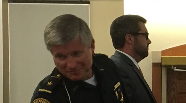 Warren County Sheriff Larry Sims shakes hands after the county commissioners set in motion plans to increase sales tax to pay for a $50 million jail.