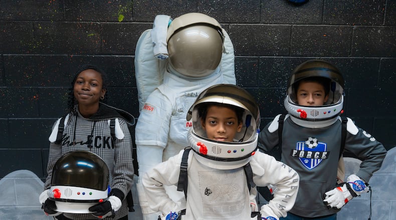 Kiser Elementary students pose next to a mannequin in the Challenger Learning Center’s Moon Room. The Moon Room is designed to teach students about the moon, and even allows them to dress up as astronauts as they explore. CONTRIBUTED