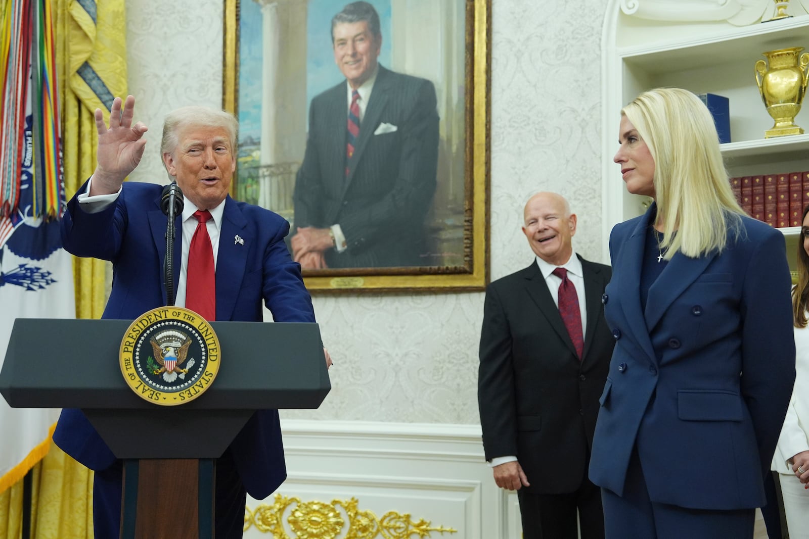 President Donald Trump, left, gestures as Attorney Genera, Pam Bondi, right, looks on during a swearing in ceremony for interim U.S. Attorney General for the District of Columbia Jeanine Pirro, Wednesday, May 28, 2025, in the Oval Office of the Whit House in Washington. (AP Photo/Evan Vucci)