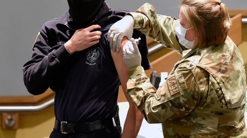 Luke Rhoades, 788th Engineer Group firefighter, receives the COVID-19 vaccine from Capt. Erica Eyer, 88MDG, flight commander, Aerospace Operational Medicine Clinic, at Wright-Patterson Air Force Base on Jan. 4, 2021. (U.S. Air Force photo by Ty Greenlees)
