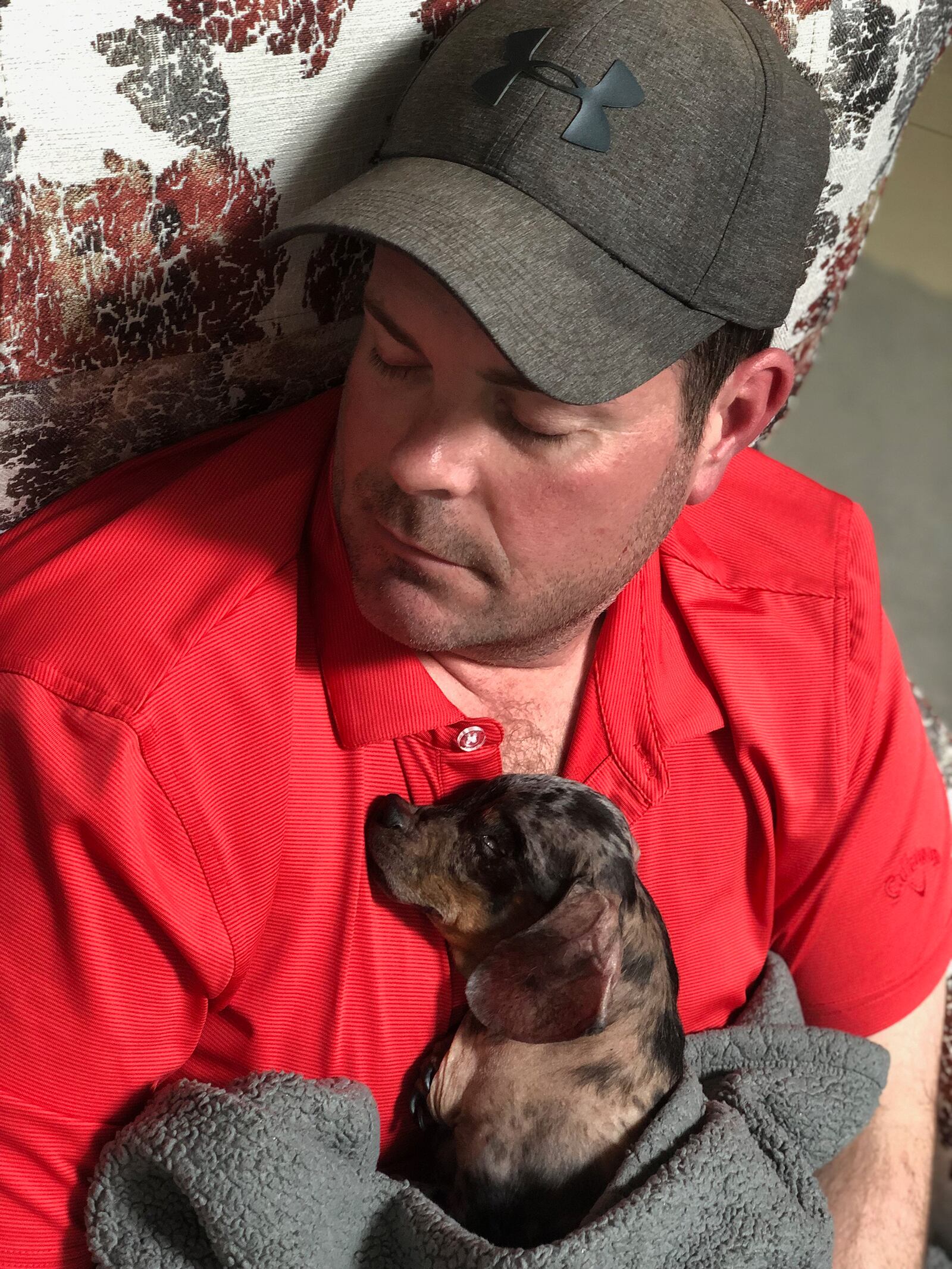 Omer developed an affinity for senior dogs and those with health issues and has adopted several. He is shown napping with one of these dogs, Smudge, who passed away in 2010. CONTRIBUTED
