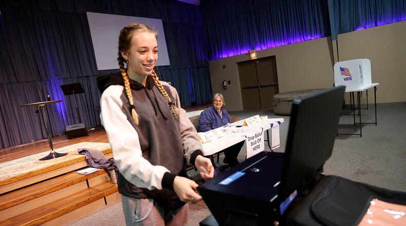Alanna Lubbers smiles as the voting machine takes her ballot Tuesday, Nov. 8, 2022 at the Trinity Missionary Church. It was Alanna's first time voting. BILL LACKEY/STAFF