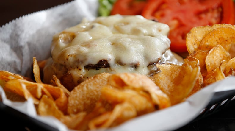 The Frisco burger at Blind Bob's in the Oregon District is served with sauteed onions, swiss chesse, thousand island dressing and grilled sourdough bread. LISA POWELL / STAFF