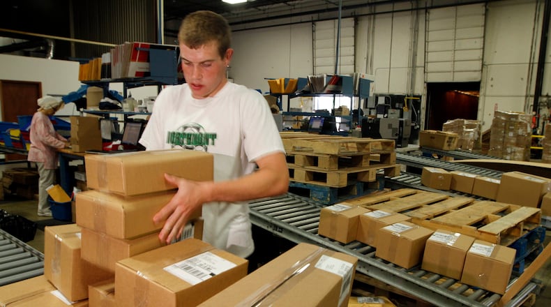 Logan Murphy, a shipping employee for Lastar, packages boxes to be sent throughout North America in this 2010 file photo. Lastar is a manufacturer of low voltage cable and connectivity products. FILE.