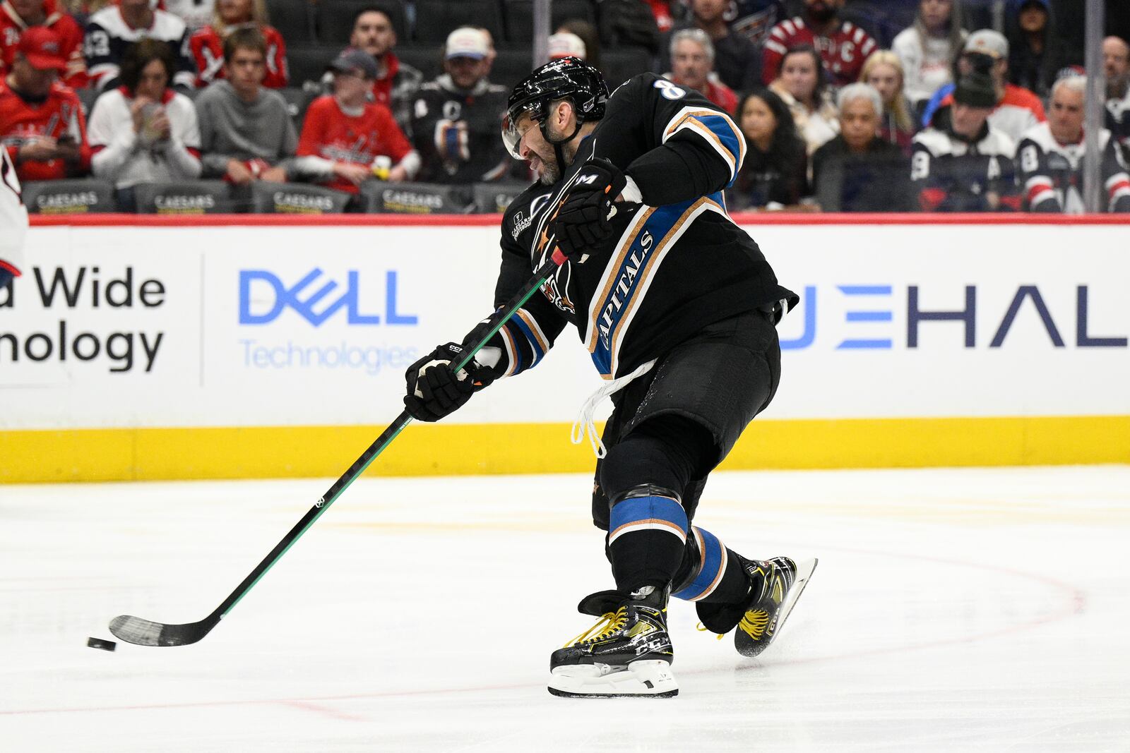 Washington Capitals left wing Alex Ovechkin (8) shoots the puck during the first period of an NHL hockey game against the Columbus Blue Jackets, Sunday, April 13, 2025, in Washington. (AP Photo/Nick Wass)
