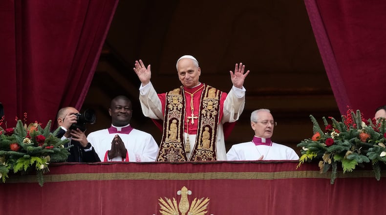 Pope Leo XIV waves after delivering the Urbi et Orbi (Latin for 'to the city and to the world' ) Christmas' day blessing from the main balcony of St. Peter's Basilica at the Vatican, Thursday, Dec. 25, 2025. (AP Photo/Gregorio Borgia)