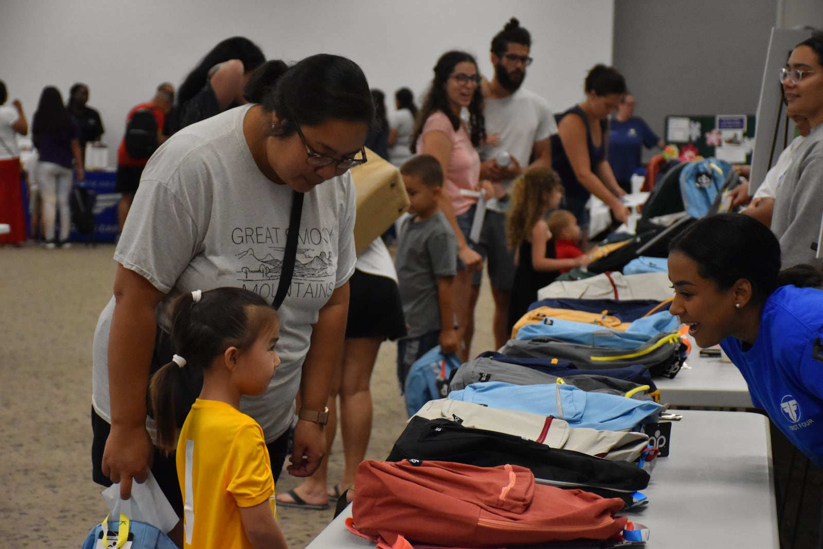 Tipp City resident Mindy Johansen and her 5-year-old daughter Ally pick out backpacks at a back-to-school supply giveaway and resource fair held Saturday, Aug. 9, 2025 at the Richard C. Holbrooke Conference Center and Hope Hotel by Wright-Patterson Air Force Base. CORNELIUS FROLIK / STAFF