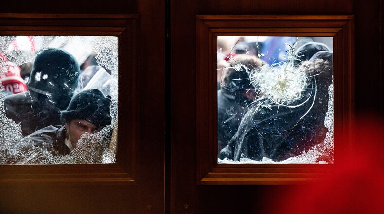 Pro-Trump protesters storm the Capitol in Washington, Wednesday, Jan. 6, 2021, on the same day as a joint session of Congress met to certify the electoral votes from the 2020 presidential election. President Trump’s efforts to overturn the 2020 presidential election came to a dangerous head on Wednesday when a mob of his supporters stormed the Capitol following a rally in which Trump once again falsely claimed widespread voter fraud. (Erin Schaff/The New York Times)