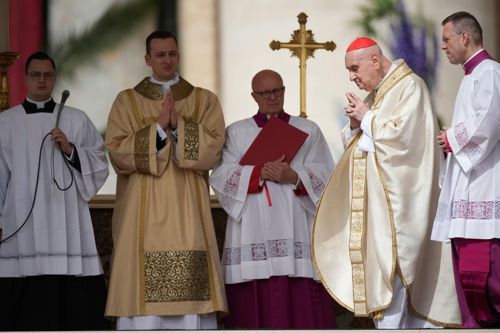 Cardinal Angelo Comastri, second from right, presides over the Easter mass in St. Peter's Square at the Vatican Sunday, April 20, 2025. (AP Photo/Andrew Medichini)