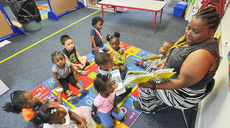 Danaye Scott reads to her class at the On Purpose Academy and Mentoring Center in Dayton. MARSHALL GORBY / STAFF