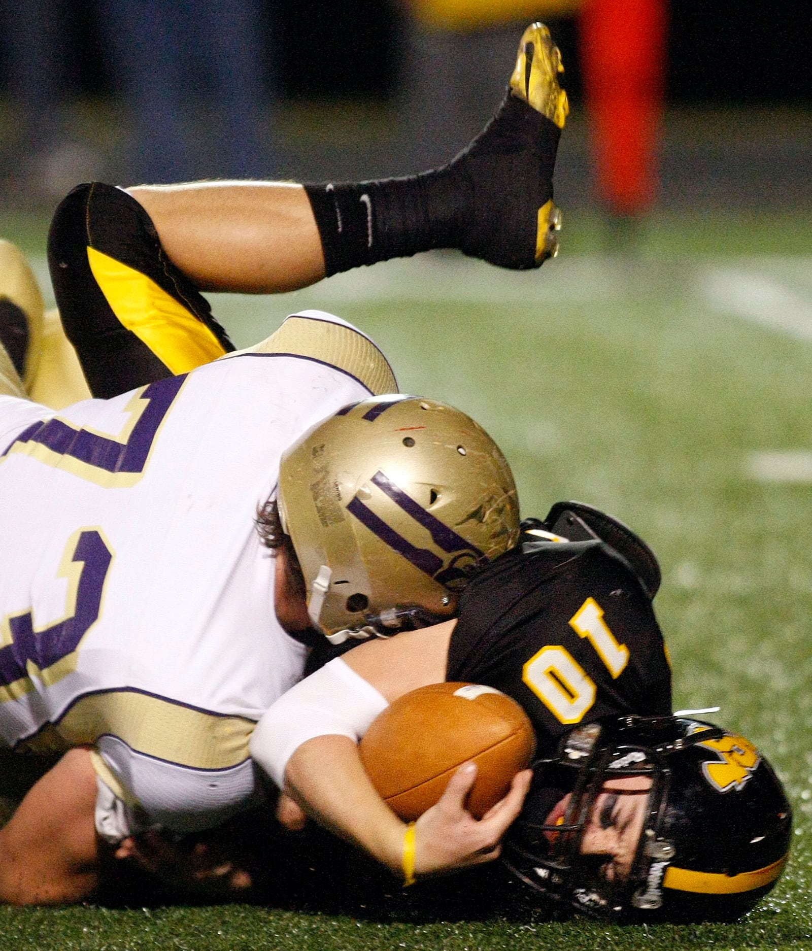 Shawnee quarterback Brad Jarzab (10) is tackled by Cody Shafer (73) of Eaton during Saturday's Division III regional semifinal football game at Northmont High School on Nov. 13, 2010. 
Staff Photo by Barbara J. Perenic