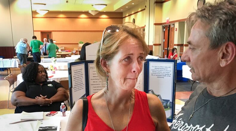 Put out of their Dayton apartment by a Memorial Day tornado, Amee Ranta and Bill Moore have struggled to find housing, resorting to sleeping on the couch of friends and some nights in their car. They sought options Tuesday at a Housing Recovery Resource Fair at the Kroc Center. CHRIS STEWART / STAFF