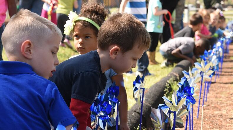 Military Child Development Centers plant pinwheels around the base to raise awareness on child abuse. The Wright-Patterson Family Advocacy Program is hosting a number of events in April to observe Child Abuse Prevention Month. (U.S. Air Force photo/Airman 1st Class Victoria Boyton)