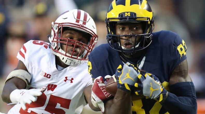 Michigan's Amara Darboh, right, makes the game-winning catch against Wisconsin's Derrick Tindal during second-half action on Saturday, Oct. 1, 2016, at Michigan Stadium in Ann Arbor, Mich. The host Wolverines won, 14-7, as Darboh scored on the 46-yard reception. (Kirthmon F. Dozier/Detroit Free Press/TNS)