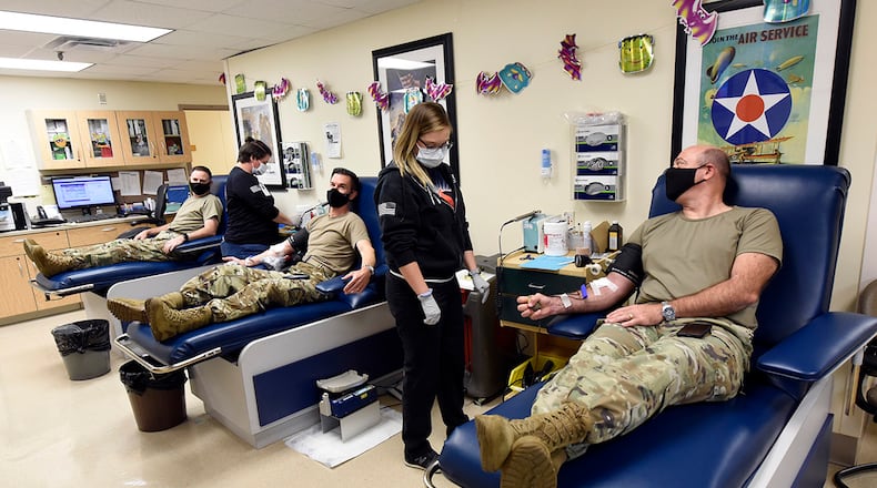 U.S. Air Force 88th Air Base Wing leaders fill the lunch hour blood-donation slots at Wright-Patterson Medical Center on Oct. 27. From left, Col. Michael Phillips, wing vice commander; Col. Paul Burger, 88th Mission Support Group commander; and Col. Patrick Miller, wing and installation commander, take part in the O-6 Blood Drive. Medical Group lab technicians Sam Mull, left, and Rachel Branham attend to the officers. U.S. AIR FORCE PHOTO/TY GREENLEES